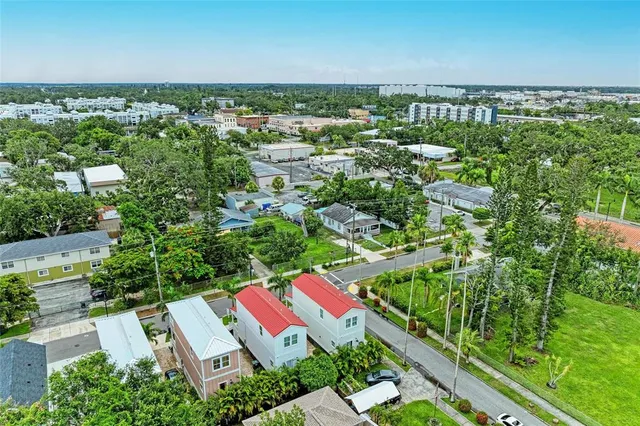 an aerial view of residential house with outdoor space and trees all around