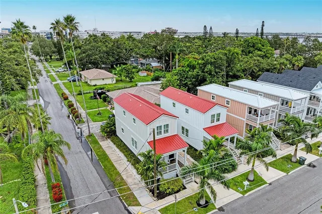 an aerial view of residential houses with outdoor space and street view