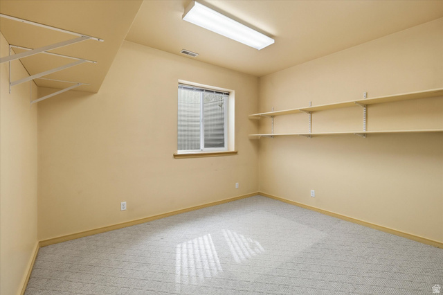560 East 700 North Logan, UT 84321 - Photo 15 of 32 Room featuring neutral-toned walls, patterned carpet flooring, and a single window with blinds