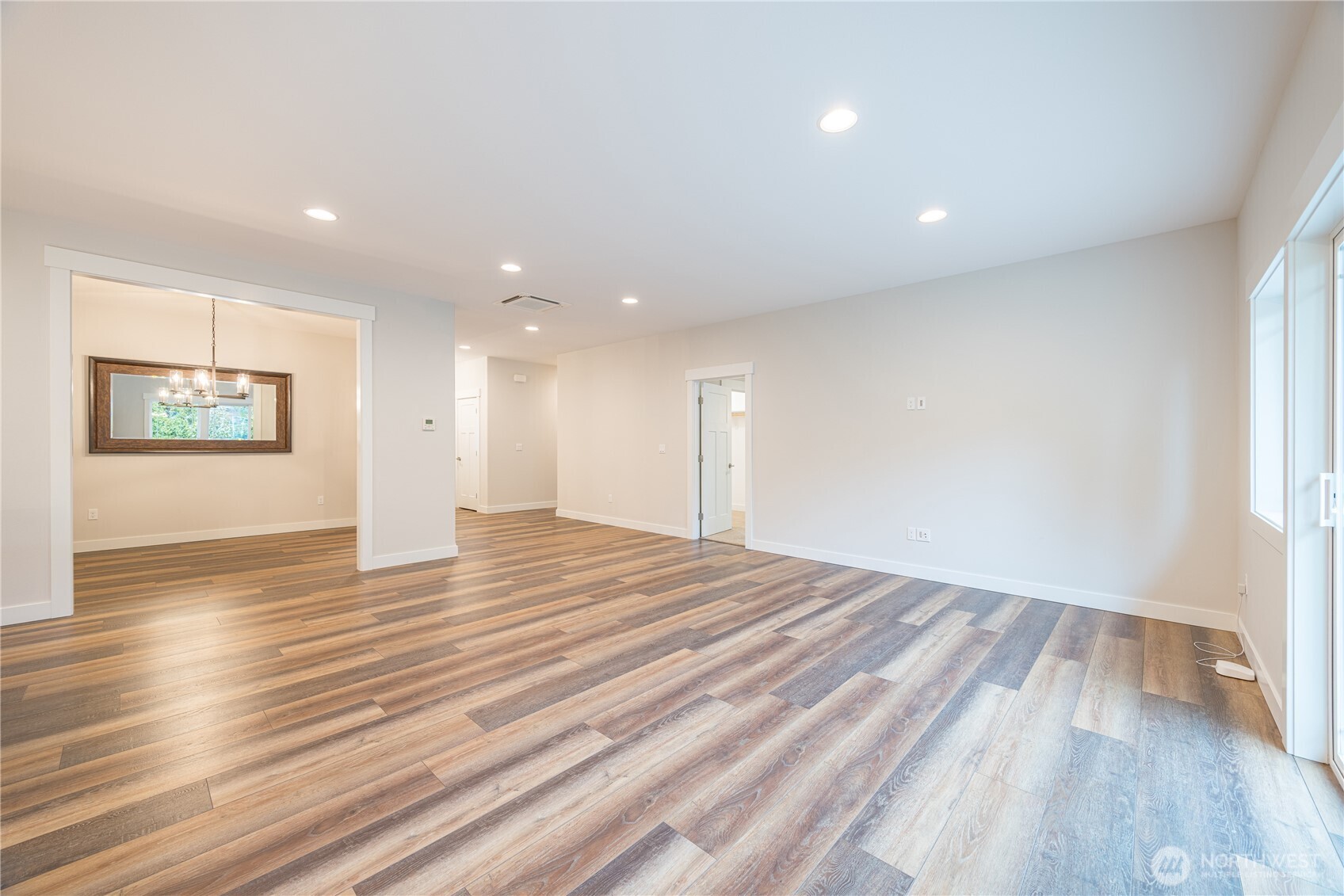 127 Sunrise View Avenue Sequim, WA 98382 - Photo 16 of 31 a view of an empty room with wooden floor and a window