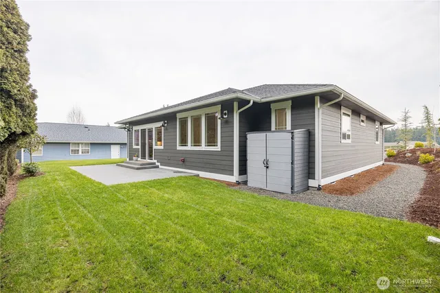 a backyard of a house with table and chairs