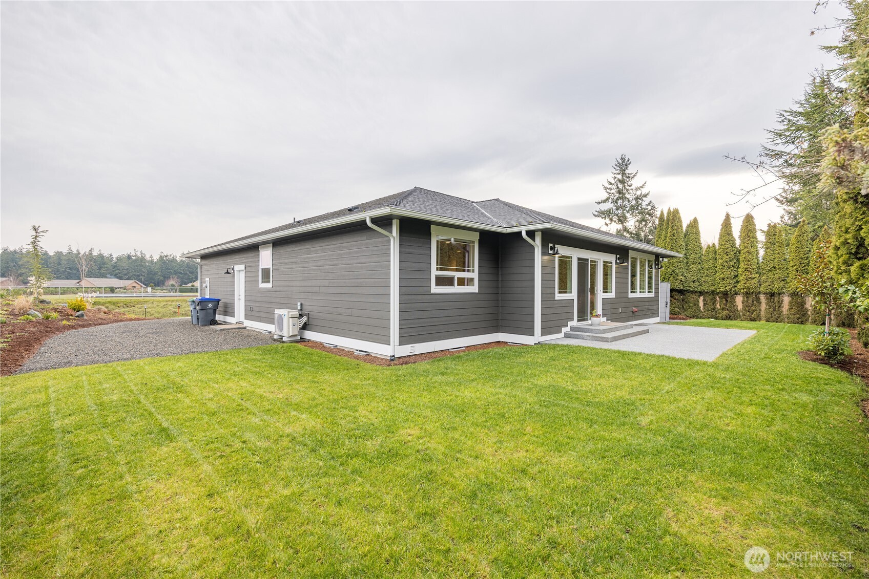127 Sunrise View Avenue Sequim, WA 98382 - Photo 31 of 31 a backyard of a house with table and chairs