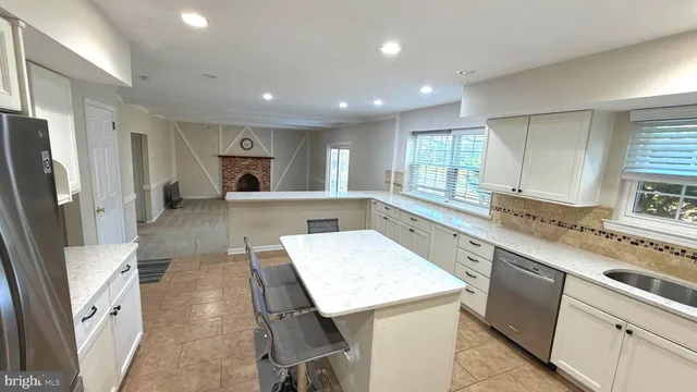 a kitchen with a sink refrigerator and microwave