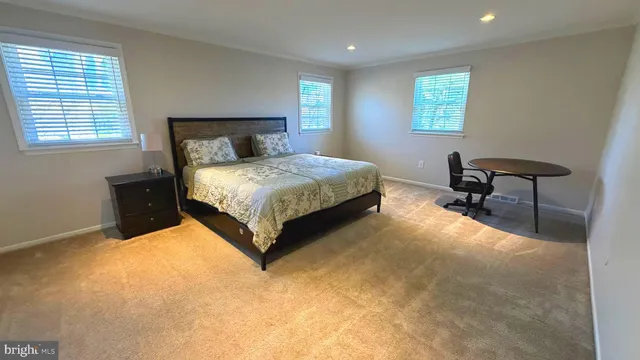a bedroom with a bed chair and a window