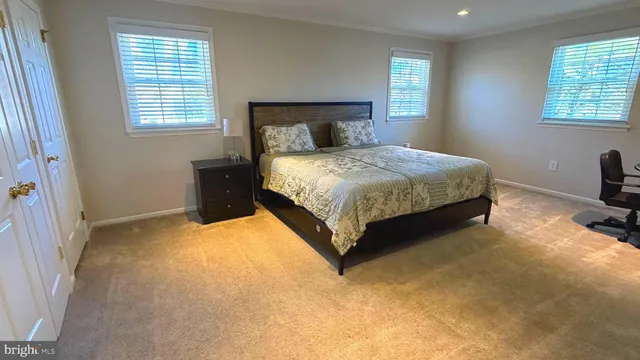 a spacious bedroom with a bed and window