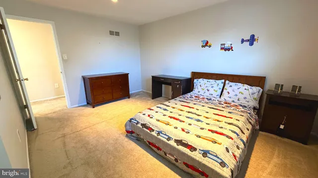 a bedroom with a bed and a television