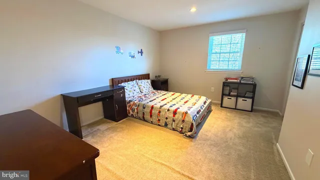 a bedroom with a bed dresser and a window