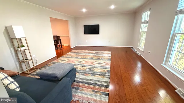 a view of a livingroom with furniture window and wooden floor