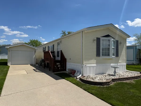 a front view of house with yard barbeque oven and outdoor seating
