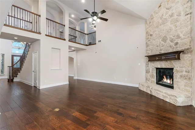 a view of empty room with wooden floor and fireplace