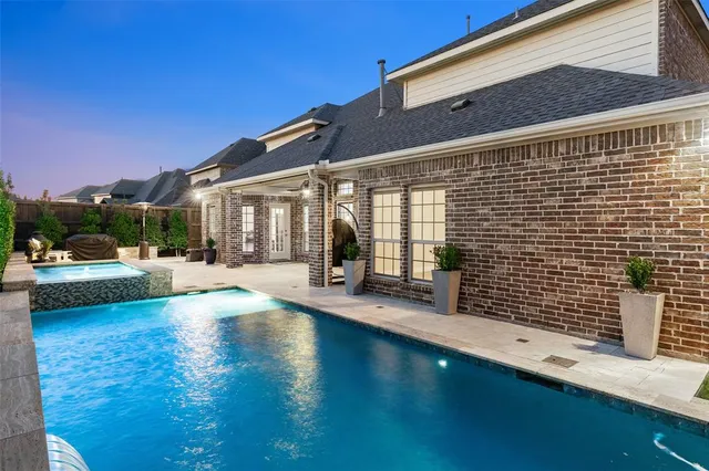 a view of a building with floor to ceiling windows and a patio