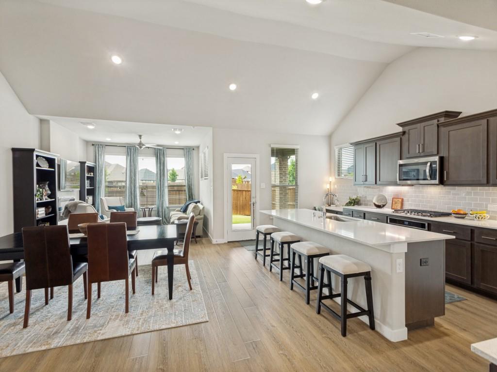10613 Smiths Bnd Road Fort Worth, TX 76126 - Photo 5 of 29 Open-concept living space featuring wood-finish flooring, recessed lighting, and vaulted ceilings