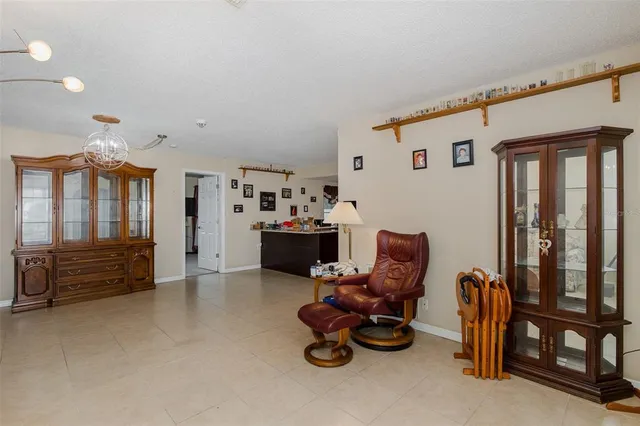 a living room with furniture chess table and a window