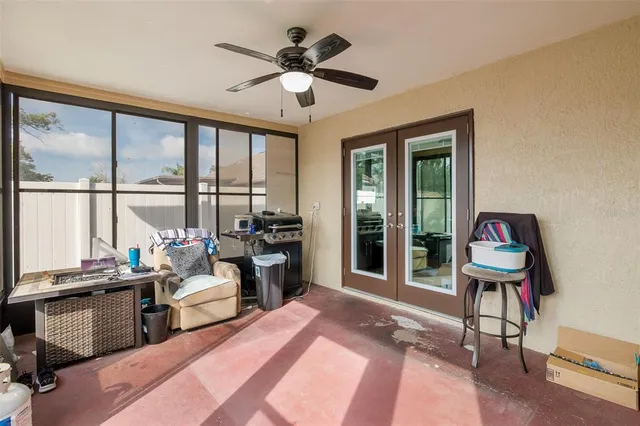 a living room with furniture and floor to ceiling windows