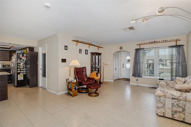 a view of a livingroom with furniture and a large window