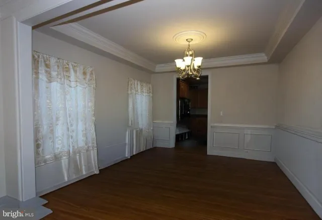 a view of a livingroom with wooden floor and a large window
