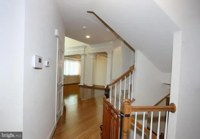 a view of entryway with wooden floor and stairs