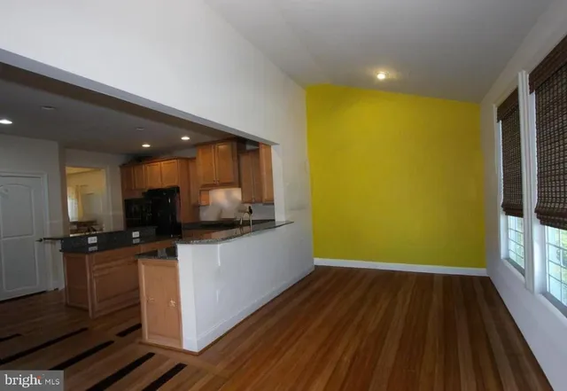 a kitchen with a sink a counter top space stainless steel appliances and cabinets