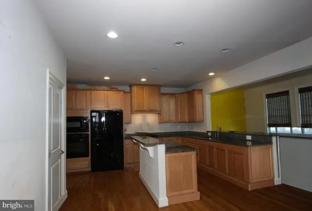 a kitchen with a refrigerator and a counter top space