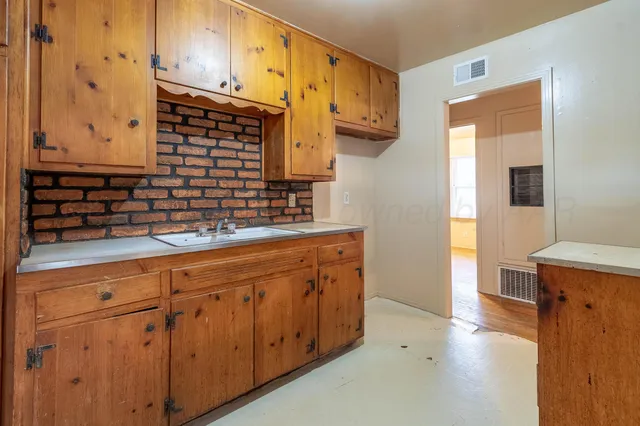 a kitchen with stainless steel appliances granite countertop a sink and cabinets
