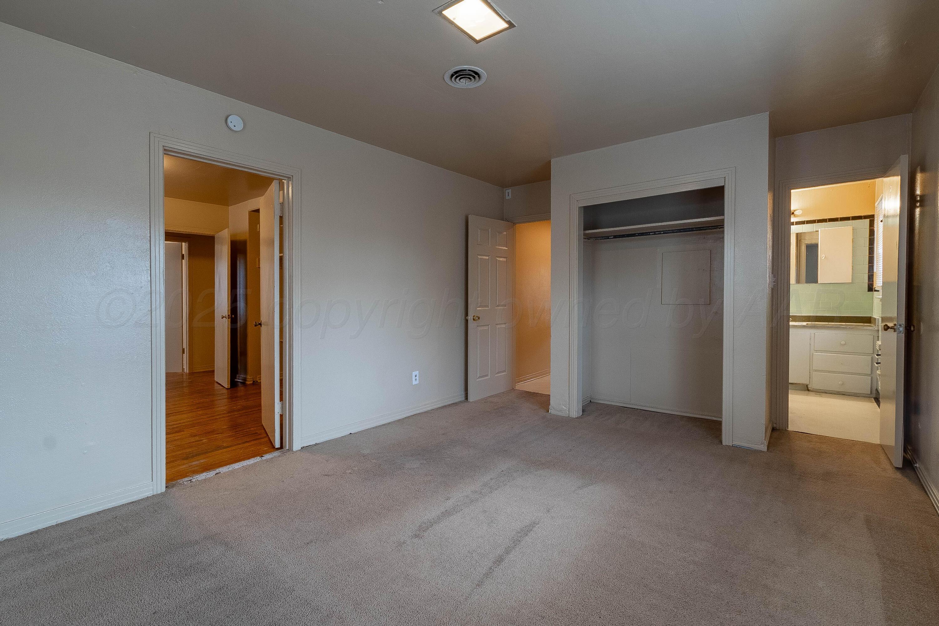 2414 Orange Street Amarillo, TX 79107 - Photo 8 of 16 a view of empty room with a fireplace