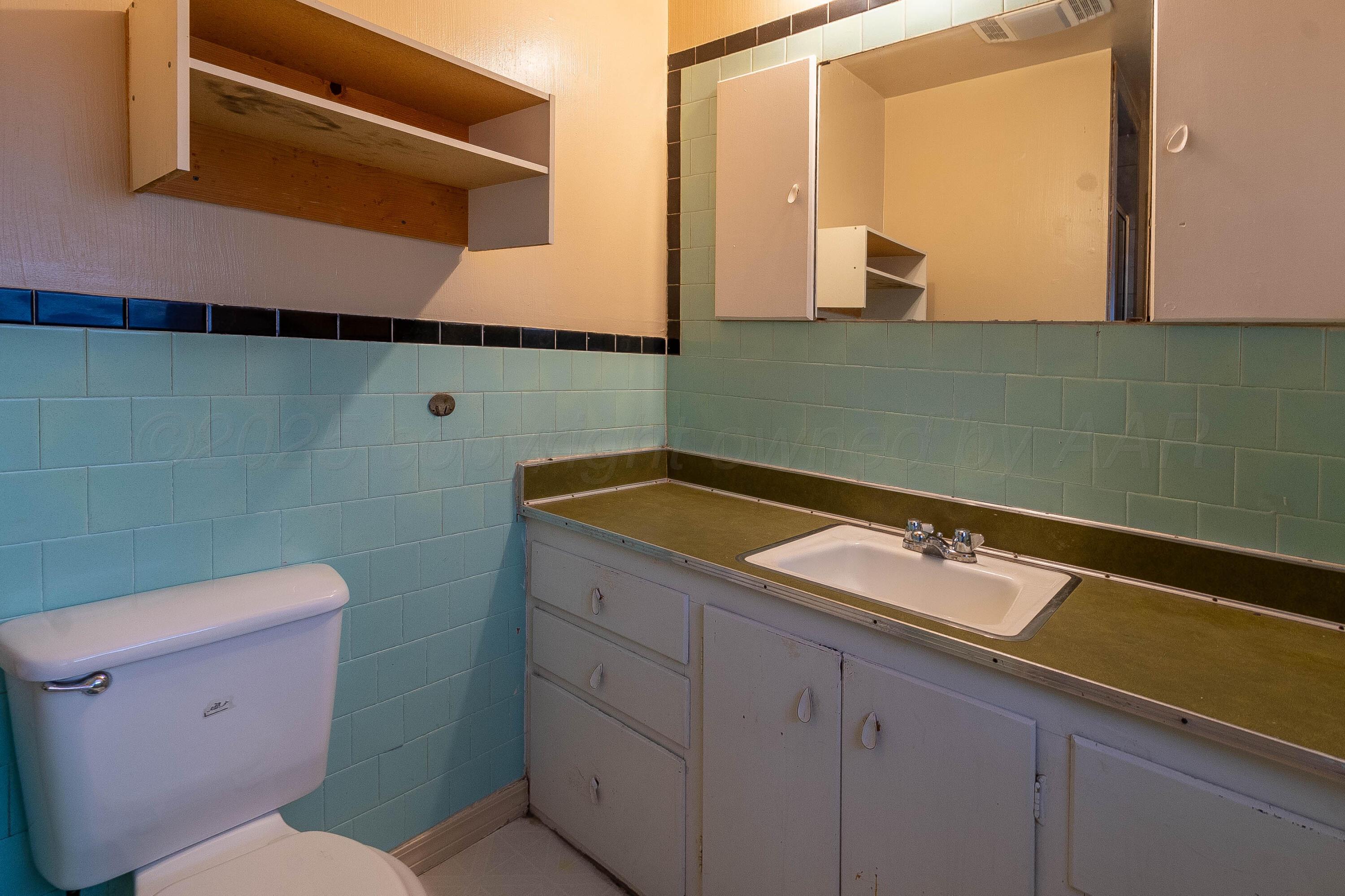 2414 Orange Street Amarillo, TX 79107 - Photo 9 of 16 a bathroom with a sink and a toilet