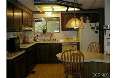 150 Clinton Road, Unit 26 Jackson, CA 95642 - Photo 4 of 5 a kitchen with a sink a stove and chairs