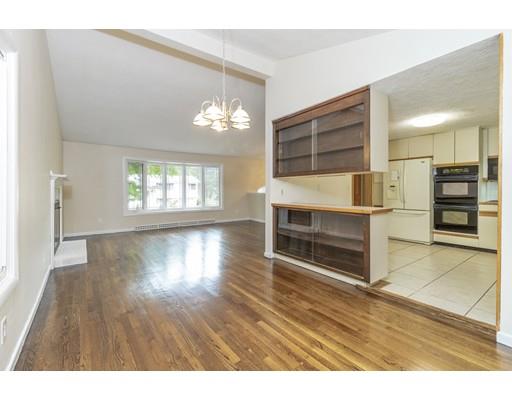 58 Oakvale Road Framingham, MA 01701 - Photo 3 of 30 an empty room with wooden floor fireplace and windows