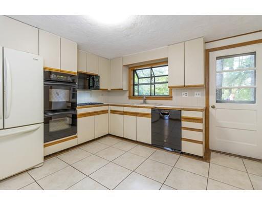 58 Oakvale Road Framingham, MA 01701 - Photo 7 of 30 a kitchen with stainless steel appliances granite countertop a stove a sink and a refrigerator