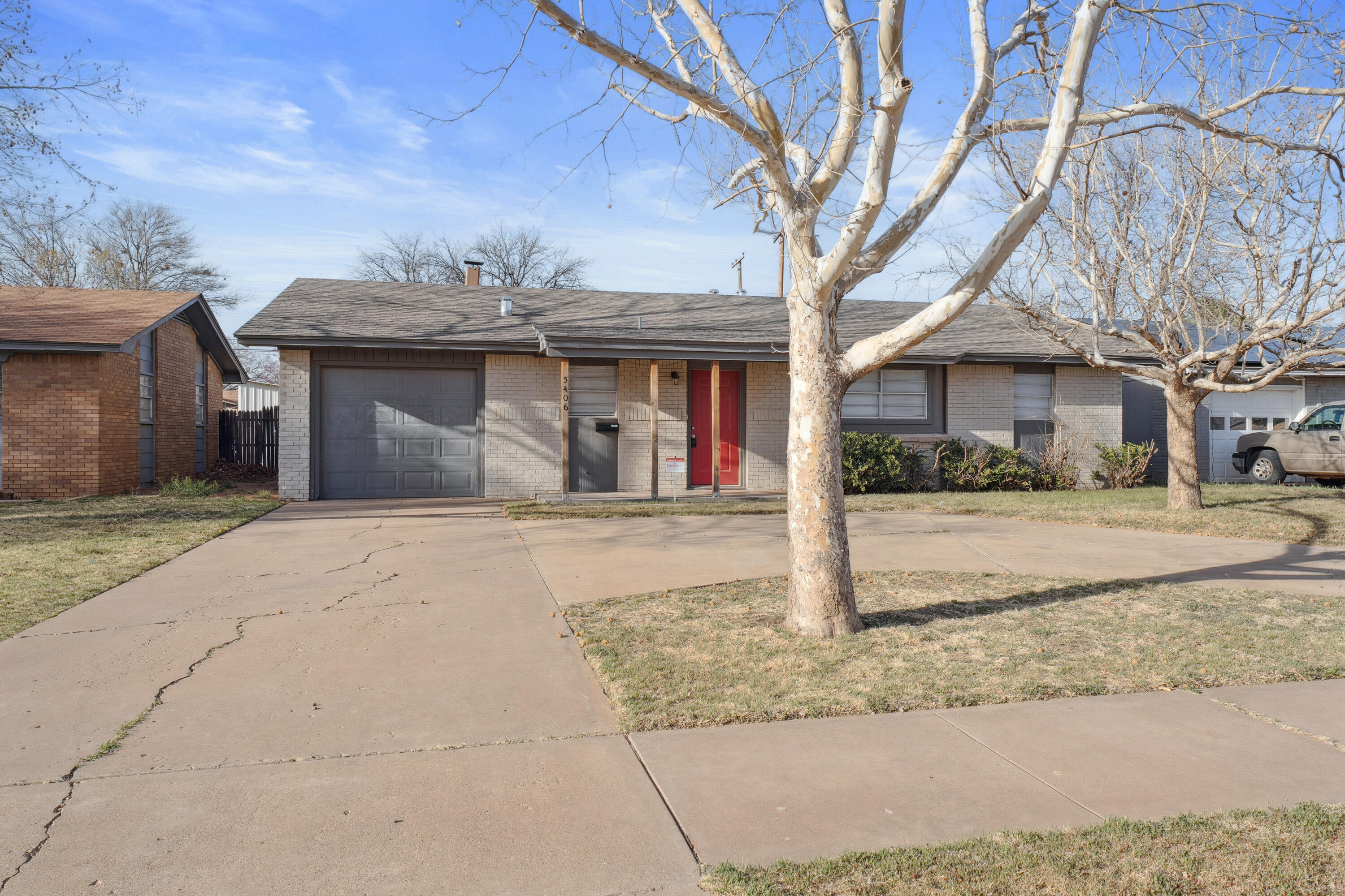 5406 49th Street Lubbock, TX 79414 - Photo 1 of 22 a front view of a house with a yard