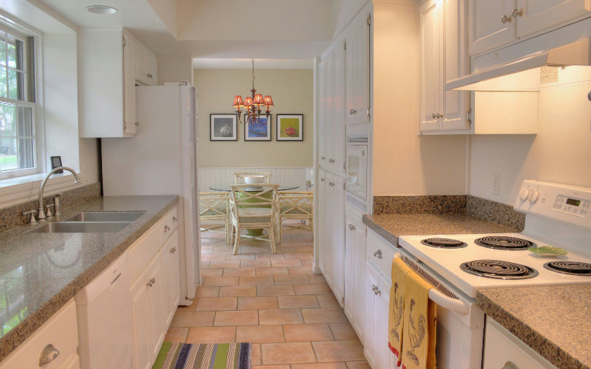 10 Willow Pond Road Fernandina Beach, FL 32034 - Photo 9 of 24 a kitchen with granite countertop a sink stove and cabinets