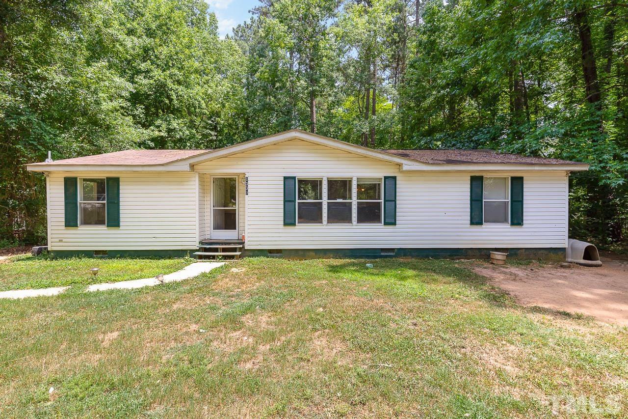 1339 Wiley Road Spring Hope, NC 27882 - Photo 1 of 22 a backyard of a house with large trees and wooden fence