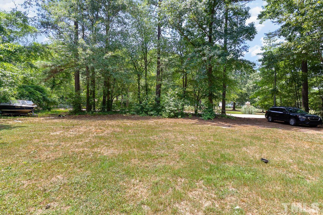 1339 Wiley Road Spring Hope, NC 27882 - Photo 22 of 22 a view of outdoor space with deck and trees