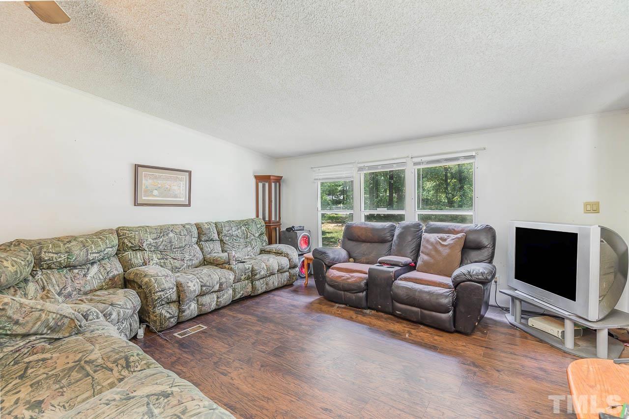 1339 Wiley Road Spring Hope, NC 27882 - Photo 5 of 22 a living room with furniture and a flat screen tv