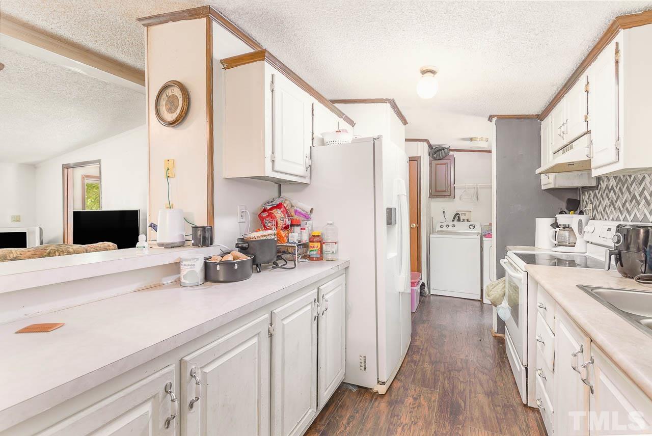 1339 Wiley Road Spring Hope, NC 27882 - Photo 6 of 22 a kitchen with a sink and a refrigerator