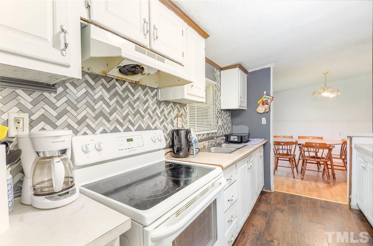 1339 Wiley Road Spring Hope, NC 27882 - Photo 7 of 22 a kitchen with stainless steel appliances granite countertop a sink and cabinets