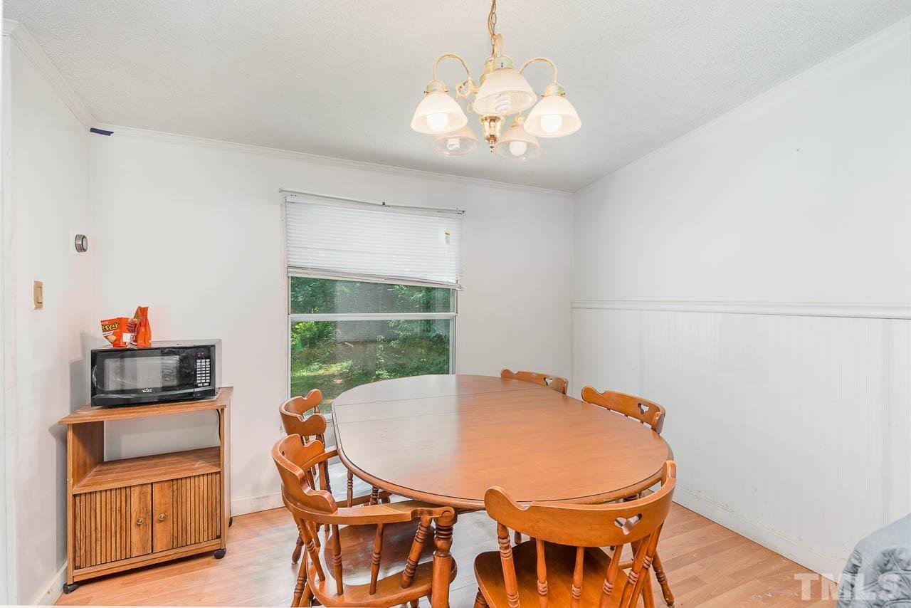 1339 Wiley Road Spring Hope, NC 27882 - Photo 8 of 22 a view of a dining room with furniture and wooden floor
