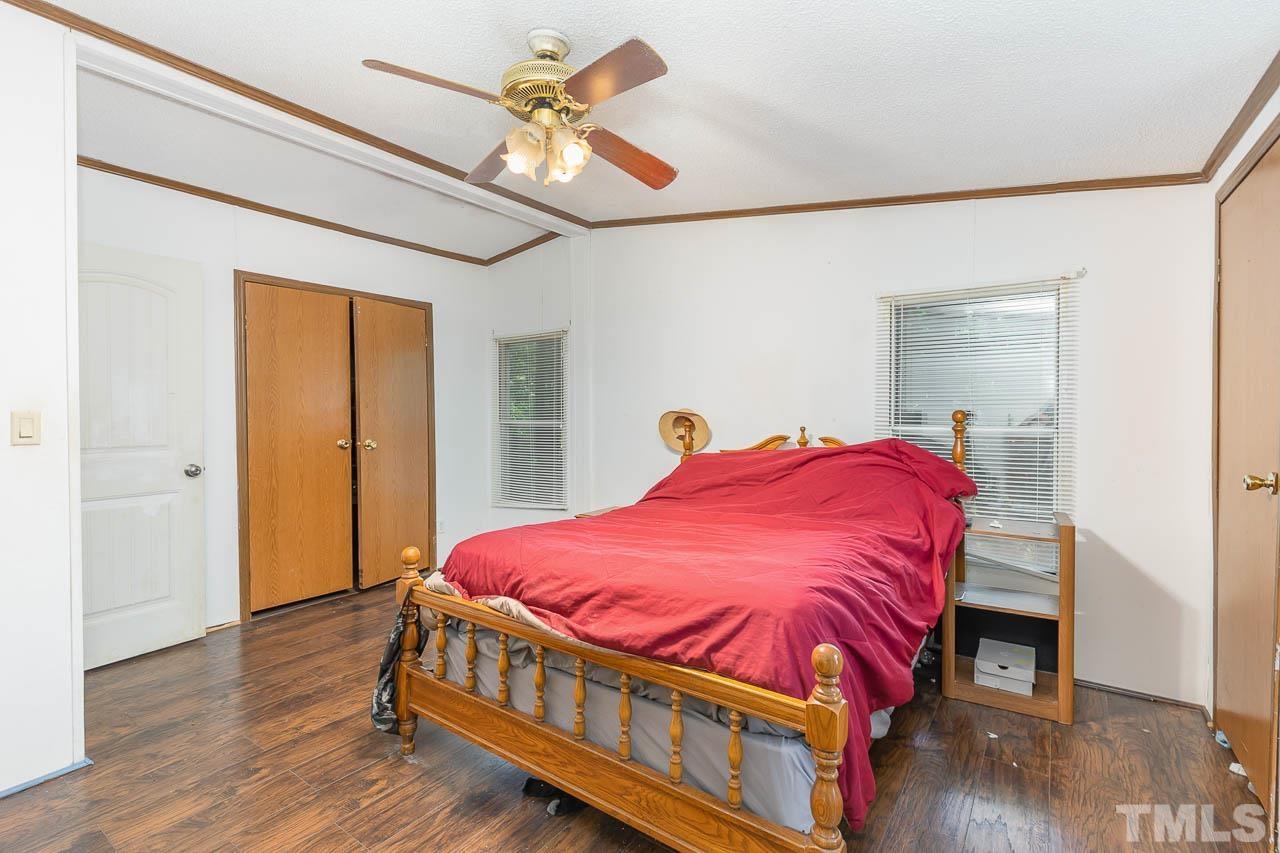 1339 Wiley Road Spring Hope, NC 27882 - Photo 10 of 22 a bedroom with a bed and wooden floor