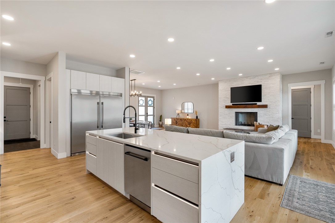 101 Casselberry Court Anderson, SC 29621 - Photo 18 of 48 This open concept living space features a gourmet kitchen island, warm wood flooring, and a modern fireplace.