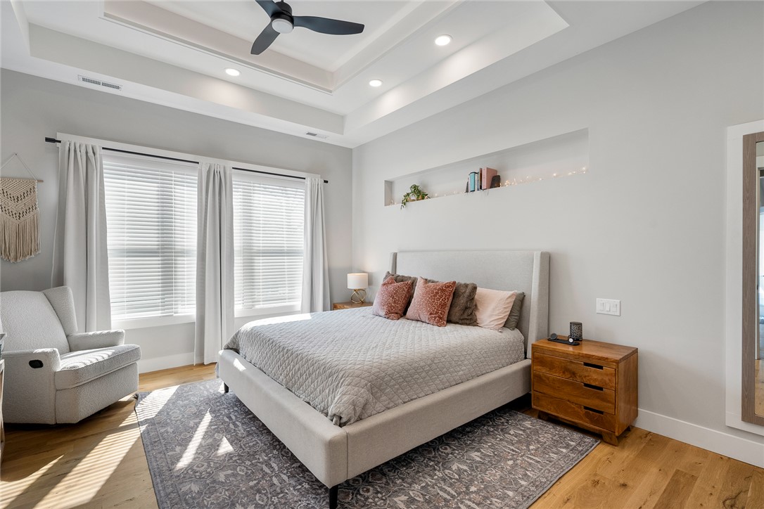 101 Casselberry Court Anderson, SC 29621 - Photo 21 of 48 This primary bedroom features elegant tray ceilings and rich hardwood flooring, creating a serene retreat.