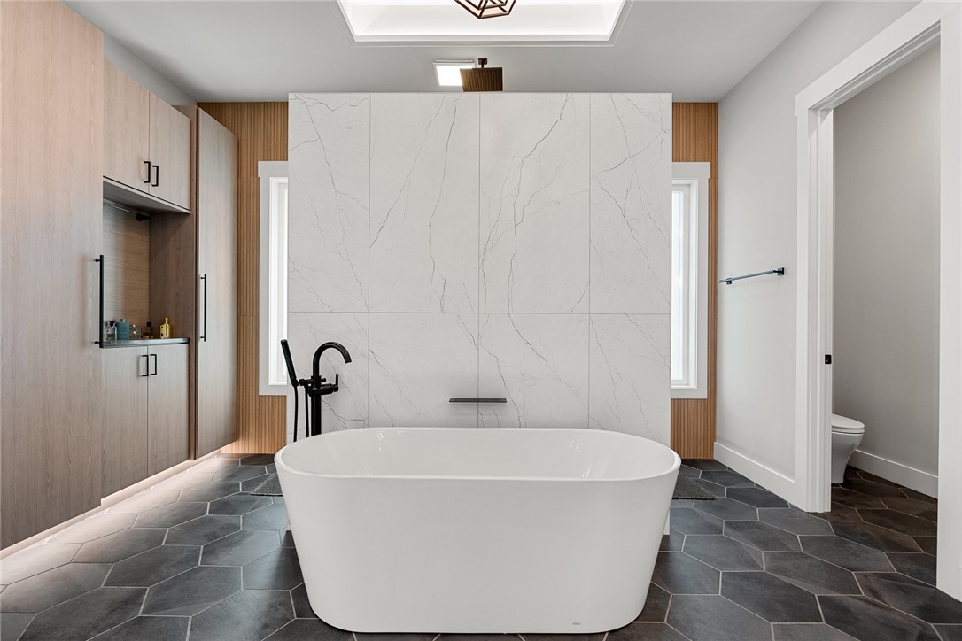 101 Casselberry Court Anderson, SC 29621 - Photo 24 of 48 This modern bathroom showcases a freestanding tub and stylish tile flooring, creating a serene retreat.