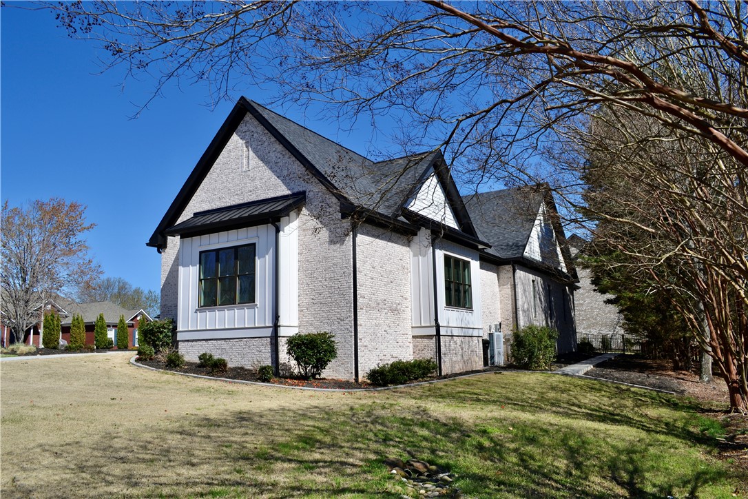 101 Casselberry Court Anderson, SC 29621 - Photo 4 of 48 This charming home features a brick and siding exterior with dark trim and a well-maintained lawn.