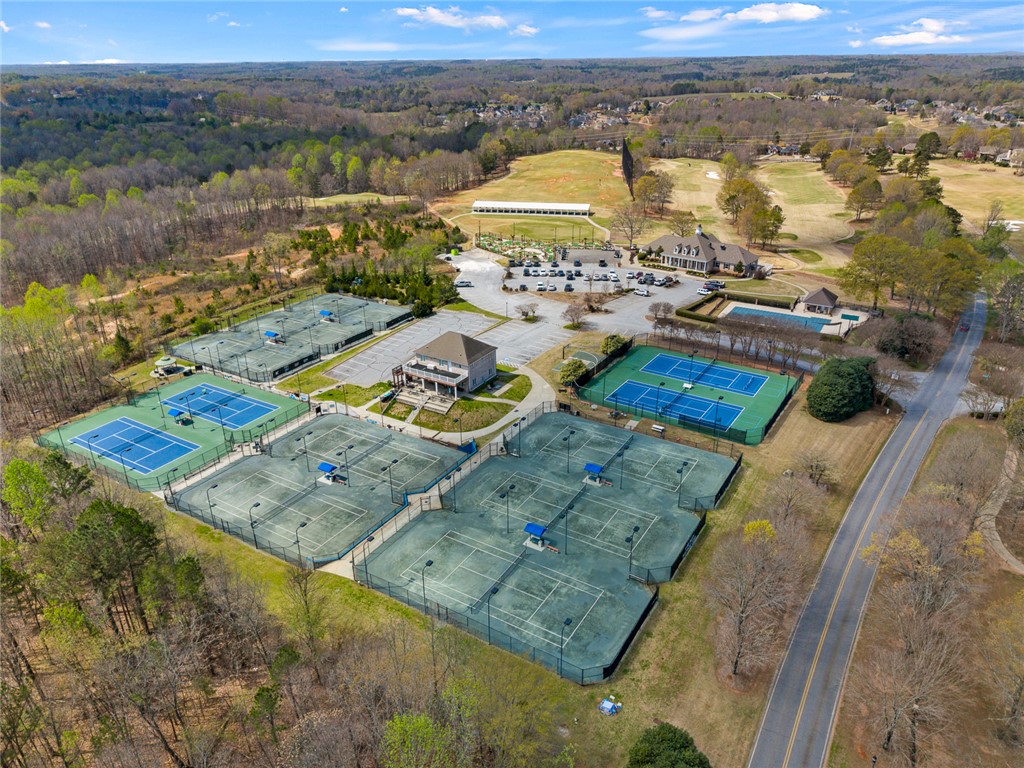 101 Casselberry Court Anderson, SC 29621 - Photo 48 of 48 This aerial view showcases extensive tennis courts, a clubhouse, and a refreshing pool, creating an active environment.