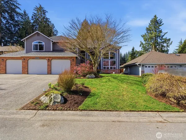 a front view of a house with a garden and yard