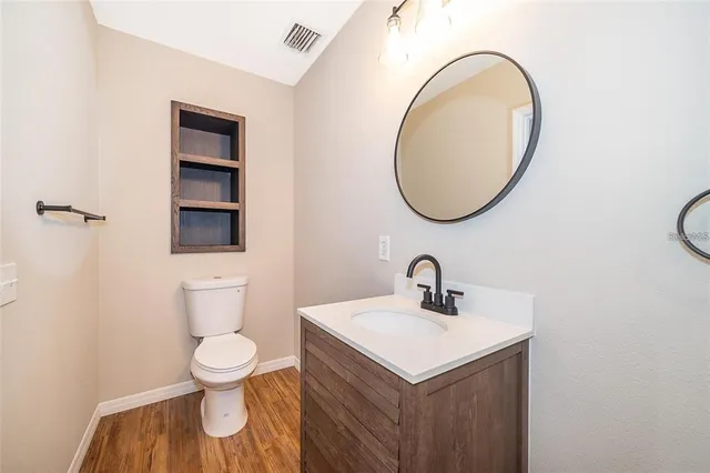 a bathroom with a sink toilet and a mirror