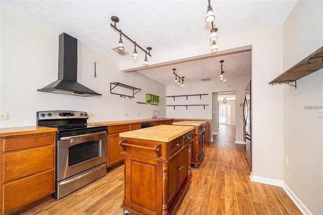 a kitchen with stainless steel appliances granite countertop a stove and a refrigerator