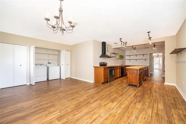a view of a kitchen with wooden floor