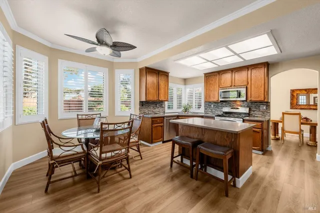 a kitchen with stainless steel appliances granite countertop a stove refrigerator sink and cabinets