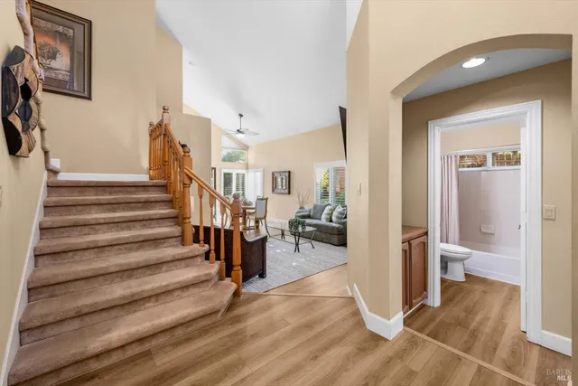 a bedroom with a bed lamps and wooden floor