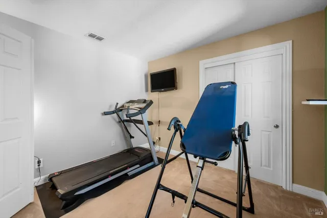 a bedroom with a bed chandelier and a window